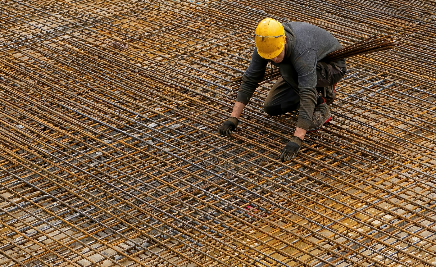 Clerk of Works inspecting a reinforcement mat before a concrete pour