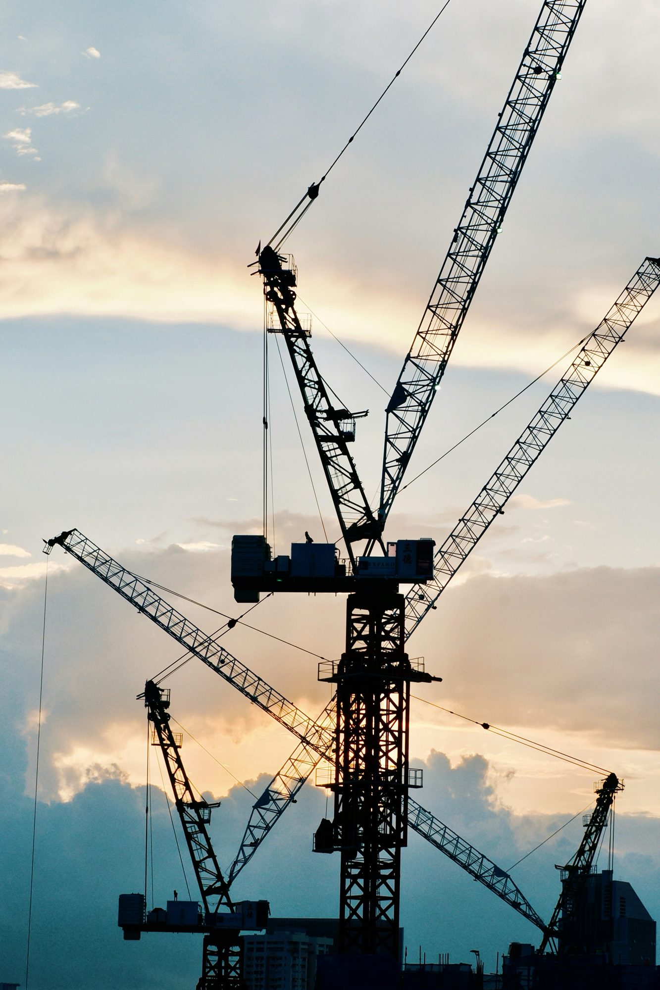 Tower cranes silhouetted at dusk